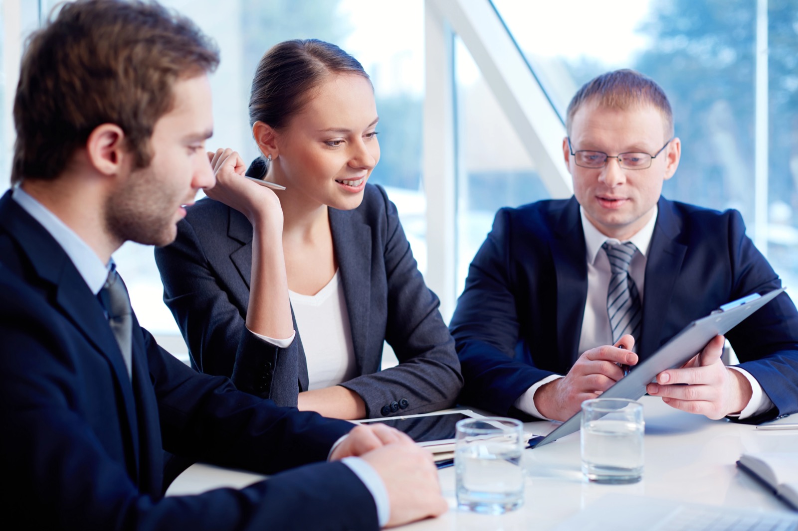 Referral professional reviewing a client proposal with colleagues